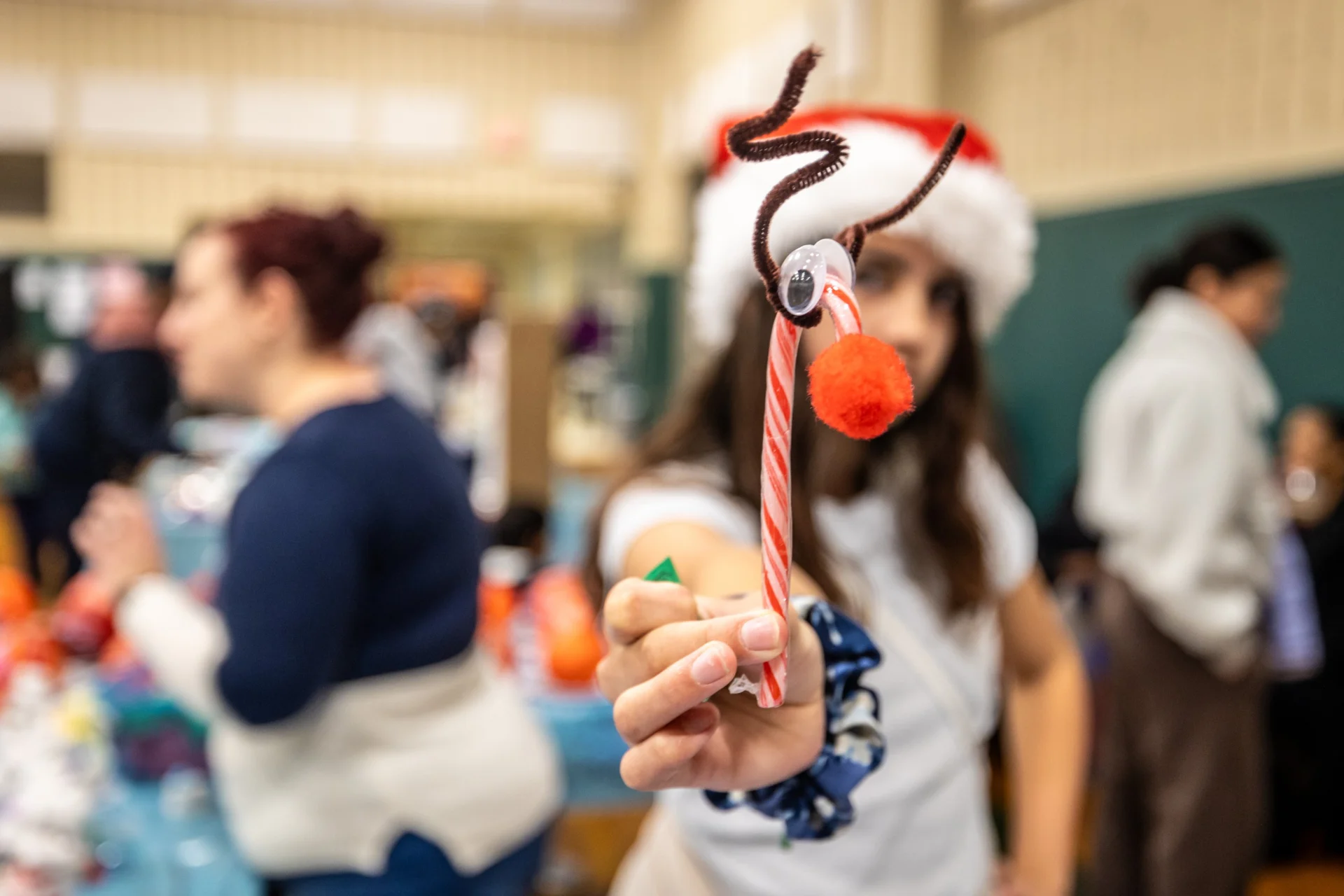 student holding a candy cane reindeer